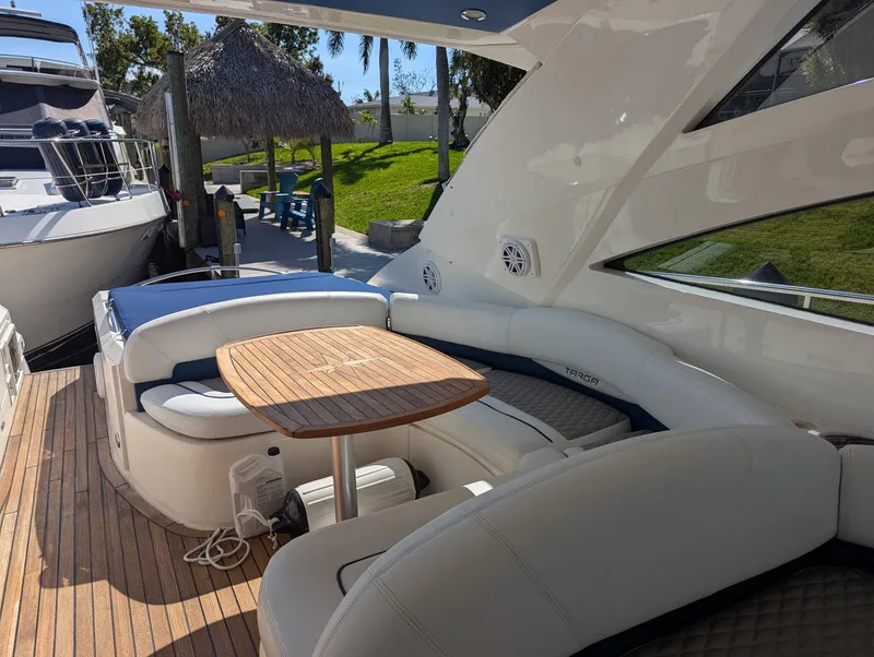 Slide: The Image of 2007 Fairline Targa 52 GT yacht with elegant seating and wooden table on deck. - 6