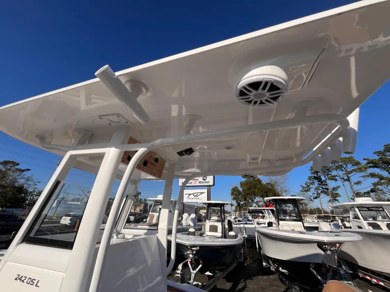 Slide: The Image of 2025 NauticStar 242L Offshore boat, showcasing sleek design and modern features under a clear blue sky. - 13