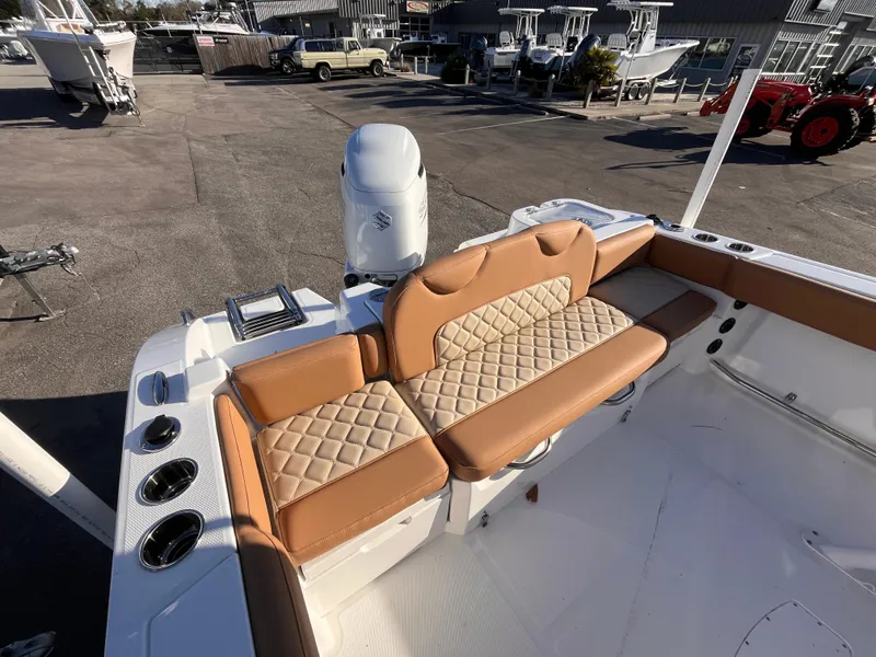 Slide: The Image of 2025 NauticStar 242L Offshore boat with tan seating and outboard motor. - 5