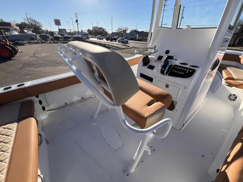 Slide: The Image of 2025 NauticStar 242L Offshore boat interior with helm and seating, showcasing modern design. - 6