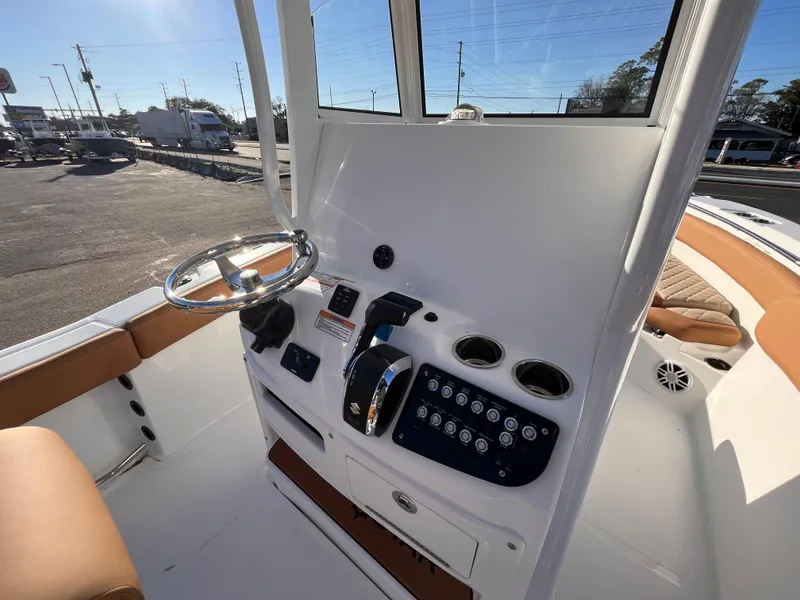 Slide: The Image of 2025 NauticStar 242L Offshore boat console with steering wheel and controls. - 7