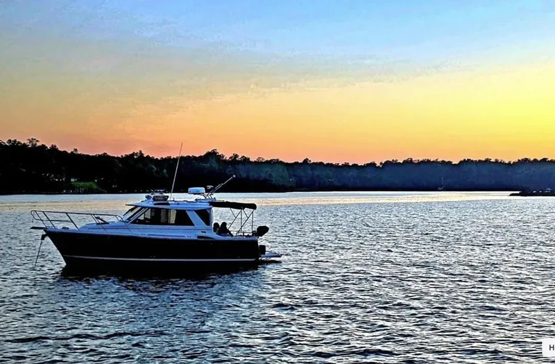 Slide: The Image of 2016 Cutwater C-26 boat on a serene lake at sunset. - 0