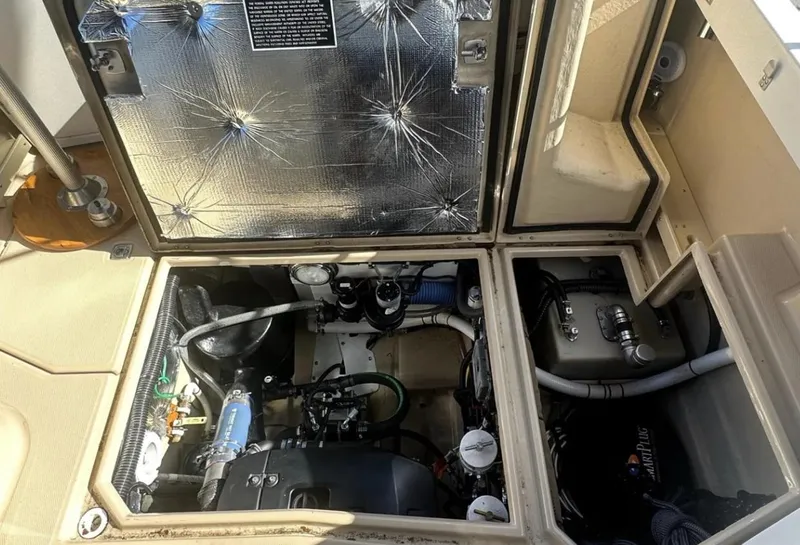 Slide: The Image of Engine compartment of a 2016 Cutwater C-26 boat, showing mechanical components and insulation. - 10