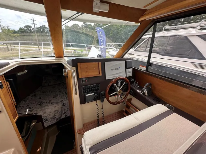 Slide: The Image of 2016 Cutwater C-26 boat interior with Garmin navigation system and wooden steering wheel. - 16