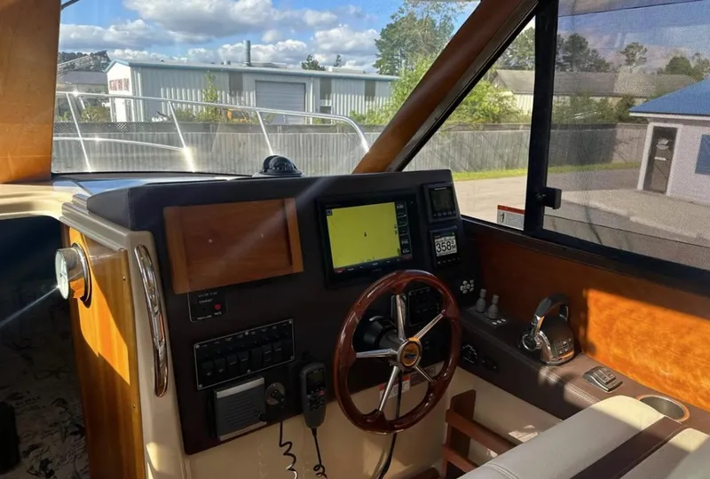 Slide: The Image of Helm of 2016 Cutwater C-26 boat with steering wheel and navigation equipment. - 17