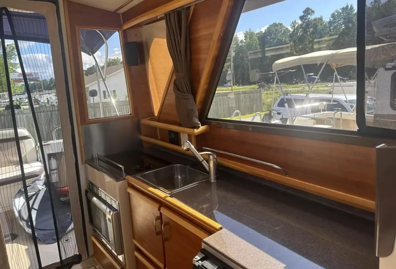 Slide: The Image of Interior of 2016 Cutwater C-26 boat with kitchen area and large windows. - 18