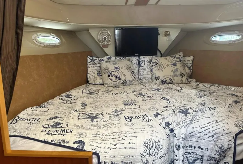 Slide: The Image of Cozy cabin interior of 2016 Cutwater C-26 boat with nautical-themed bedding. - 23