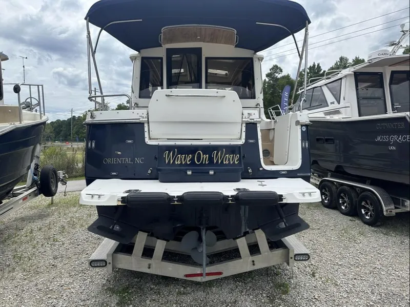 Slide: The Image of 2016 Cutwater C-26 boat named "Wave On Wave" on a trailer in a marina. - 5