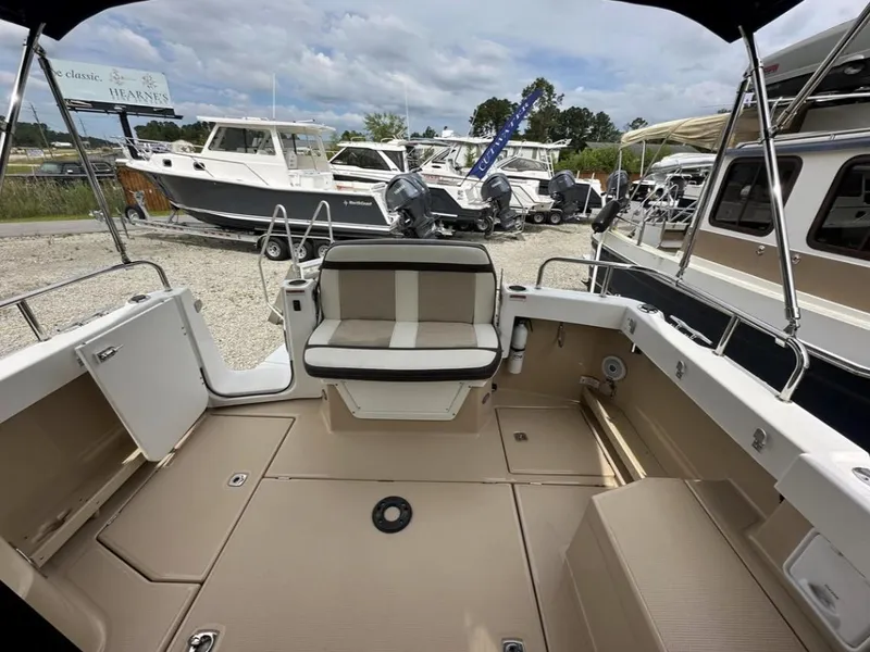 Slide: The Image of 2016 Cutwater C-26 boat interior with seating, docked among other boats. - 9