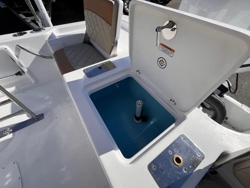 Slide: The Image of 2025 NauticStar 194 Bay boat interior with open storage compartment and seating. - 15