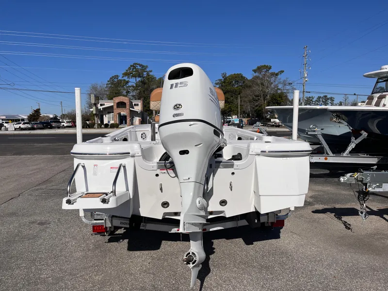 Slide: The Image of 2025 NauticStar 194 Bay boat with outboard motor, parked on a trailer. - 3