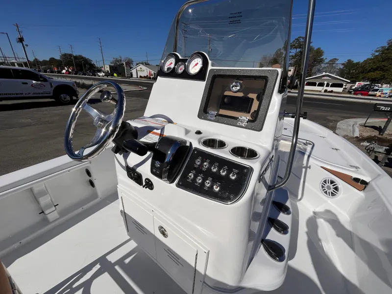 Slide: The Image of 2025 NauticStar 194 Bay boat console with steering wheel and controls. - 7