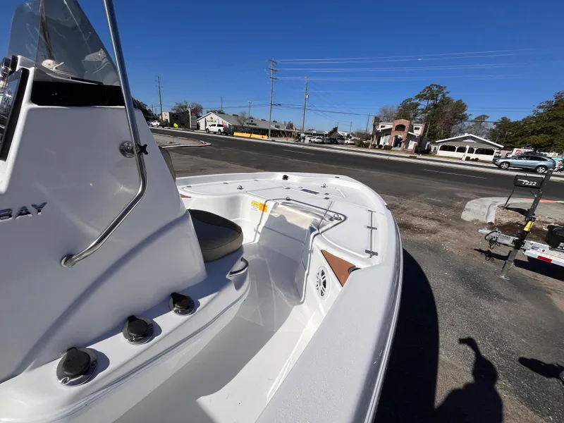 Slide: The Image of 2025 NauticStar 194 Bay boat parked outdoors on a sunny day. - 8