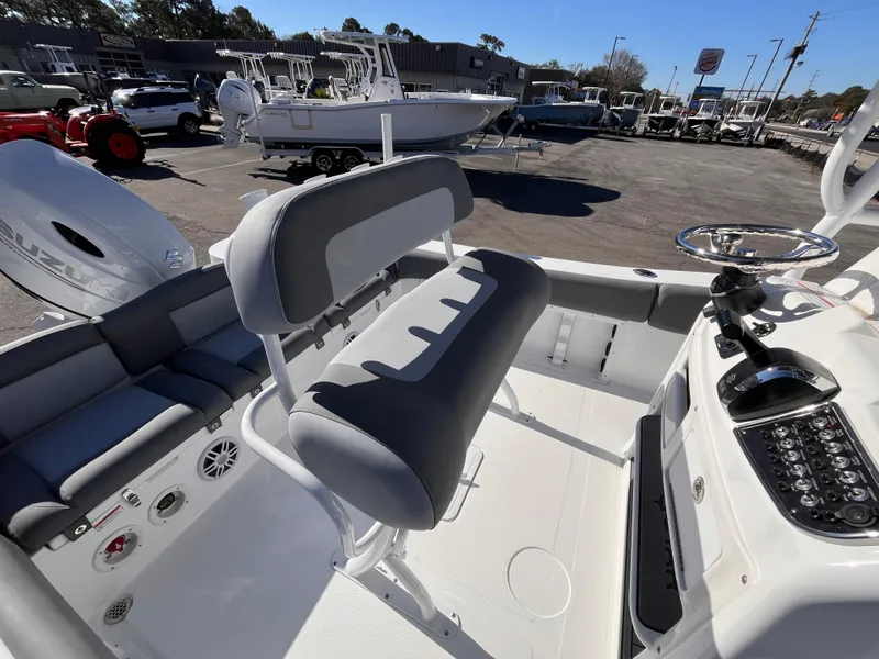 Slide: The Image of 2025 NauticStar 212 Legacy boat interior with seating and control panel. - 6