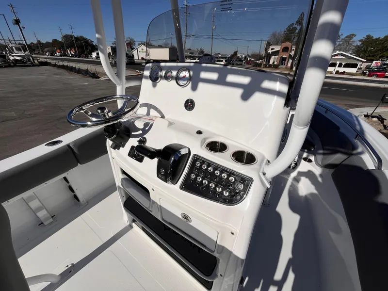 Slide: The Image of 2025 NauticStar 212 Legacy boat console with steering wheel and control panel. - 7