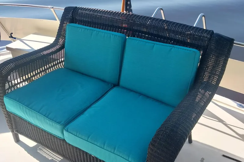 Slide: The Image of Wicker loveseat with blue cushions on 1988 Hatteras 40 Double Cabin yacht deck. - 12