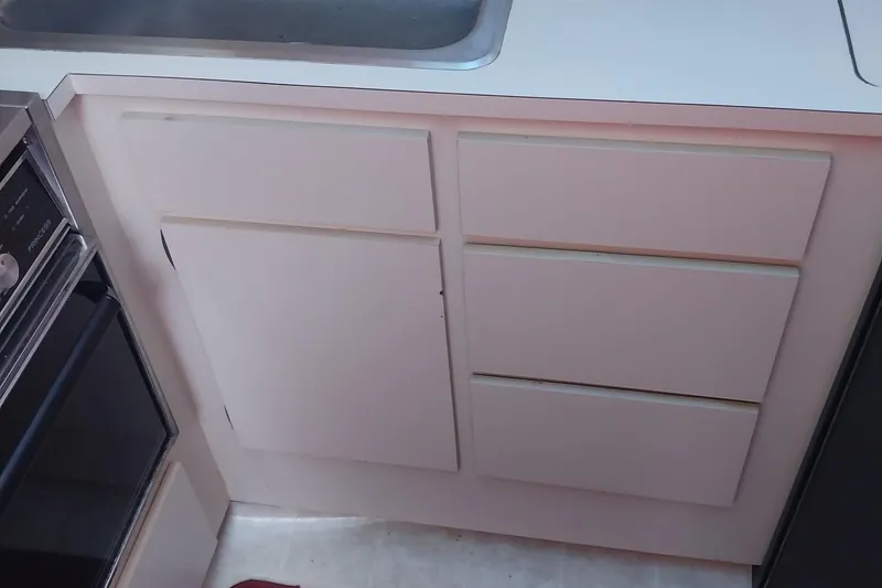 Slide: The Image of 1988 Hatteras 40 Double Cabin kitchen cabinetry with sink and oven. - 15