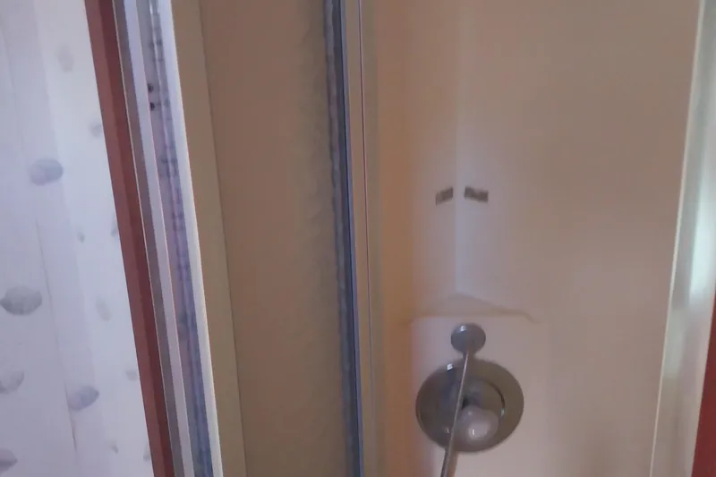 Slide: The Image of Shower area inside 1988 Hatteras 40 Double Cabin yacht, featuring a sleek design. - 21