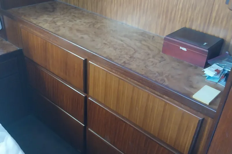 Slide: The Image of Wooden cabinet in 1988 Hatteras 40 Double Cabin interior, with a small box on top. - 25