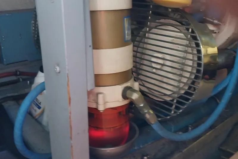 Slide: The Image of Engine room of 1988 Hatteras 40 Double Cabin with visible machinery and hoses. - 28