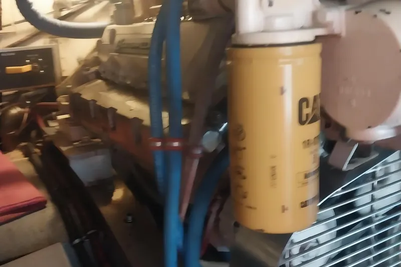 Slide: The Image of Engine room of 1988 Hatteras 40 Double Cabin with visible CAT filter and components. - 29
