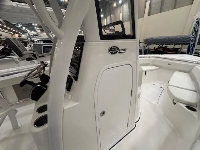 Slide: The Image of 2025 Sea Pro 242 Center Console boat interior at a showroom display. - 18