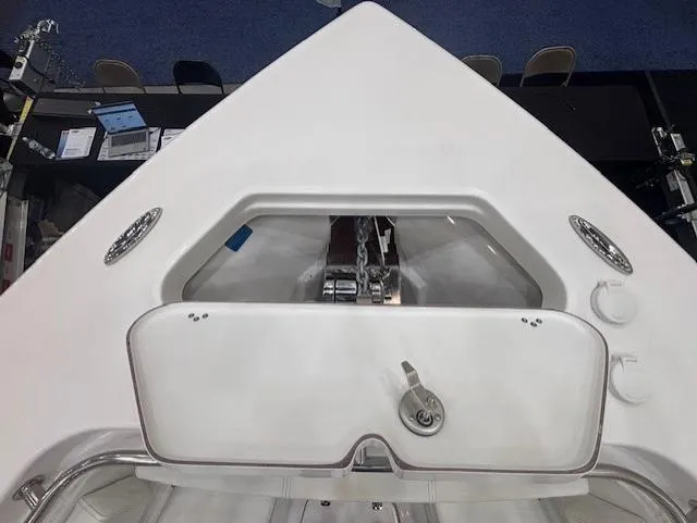 Slide: The Image of 2025 Sea Pro 242 Center Console boat bow with anchor storage and sleek design. - 22