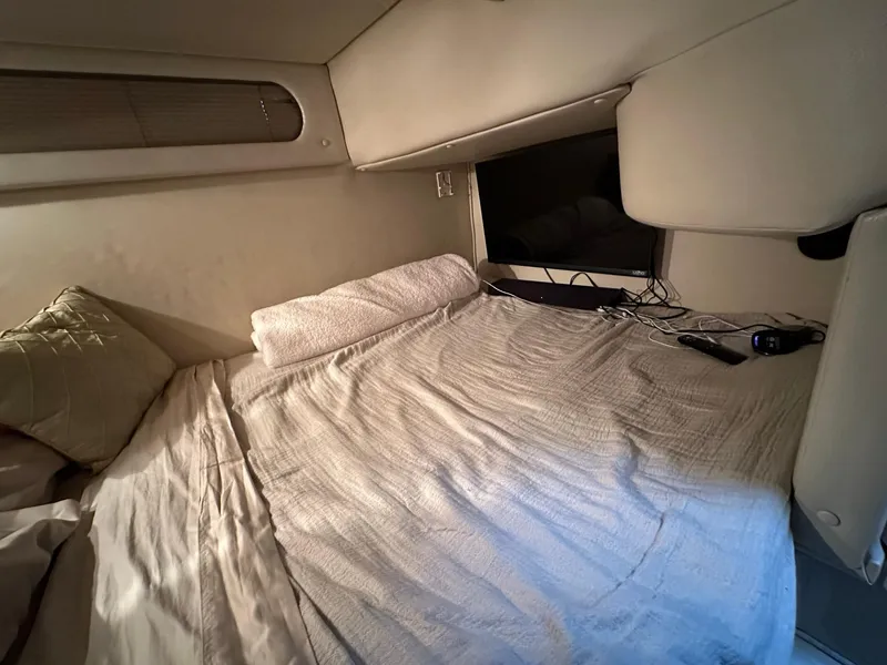 Slide: The Image of 2003 Chaparral Signature 280 cabin interior with cozy bed and window view. - 22