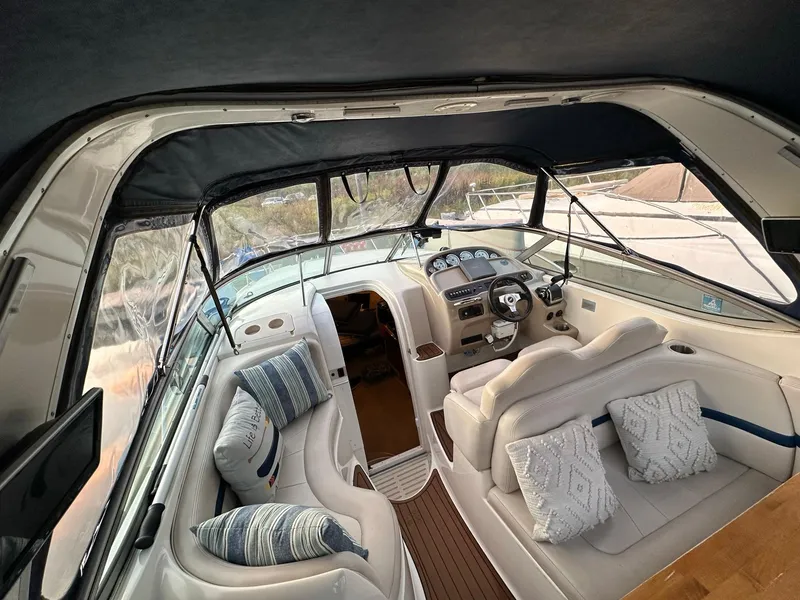 Slide: The Image of Interior of 2003 Chaparral Signature 280 boat with plush seating and helm. - 24