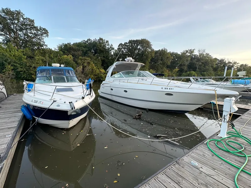 Slide: The Image of Two boats docked, including a 2003 Chaparral Signature 280, in a serene marina setting. - 28