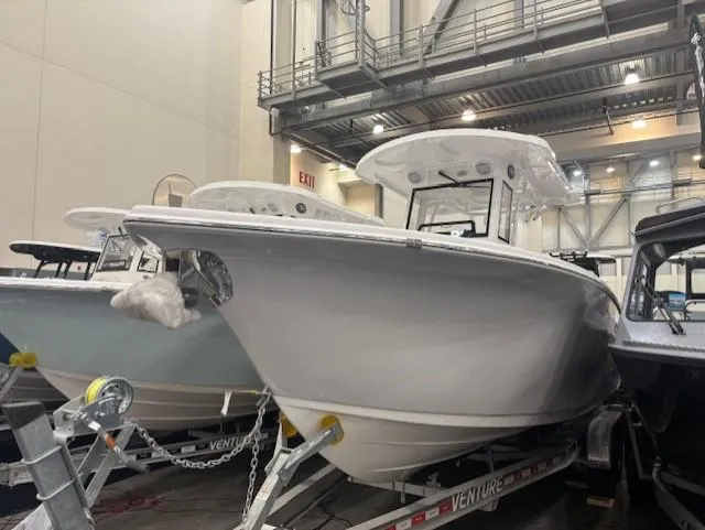The Image of 2025 Sea Pro 262 Offshore boat displayed indoors on a trailer. - 0