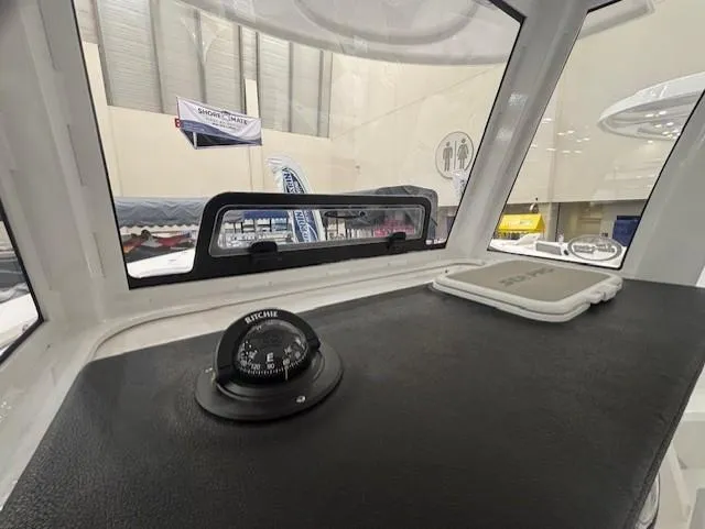 Slide: The Image of 2025 Sea Pro 262 Offshore boat interior at a showroom, featuring sleek design and spacious layout. - 18