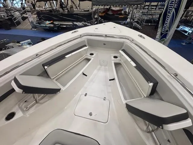 Slide: The Image of 2025 Sea Pro 262 Offshore boat console with steering wheel and controls in a showroom. - 25