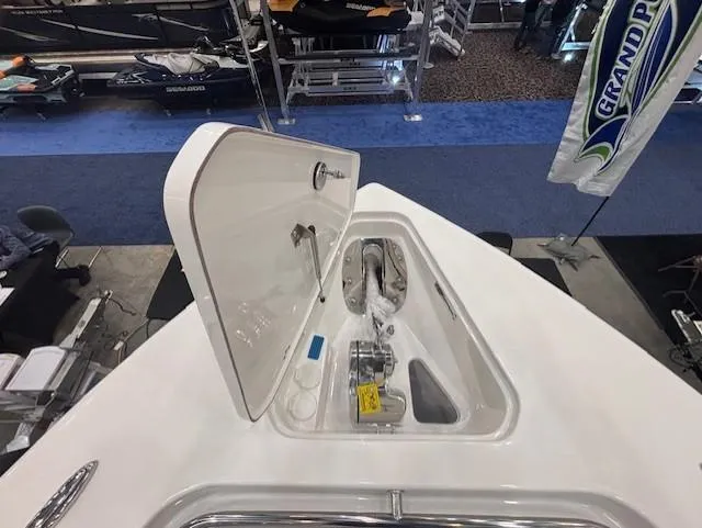 Slide: The Image of 2025 Sea Pro 262 Offshore boat dashboard with Simrad electronics and steering wheel. - 26