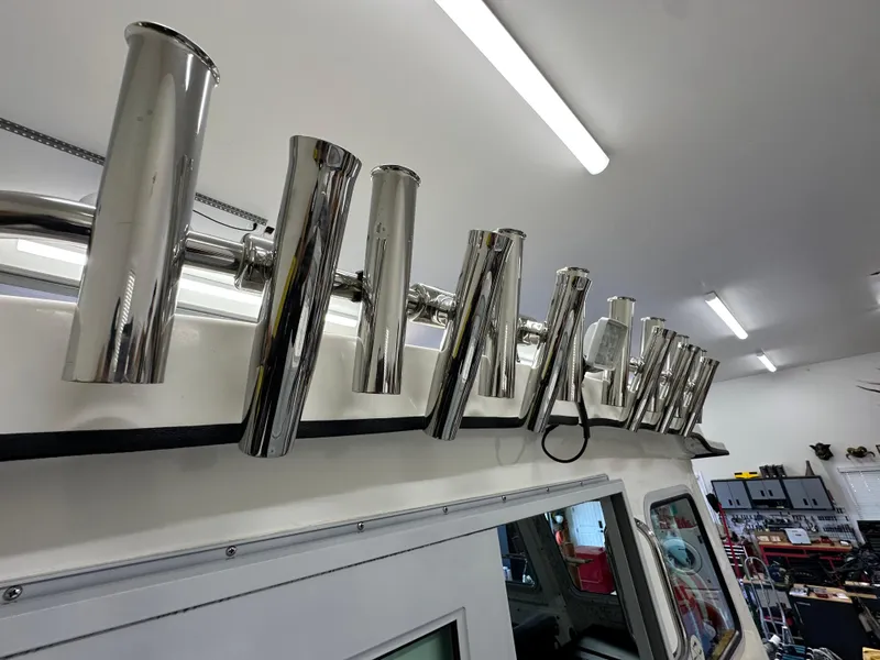 Slide: The Image of Stainless steel rod holders on a 2005 Farallon 28 boat in a workshop. - 16