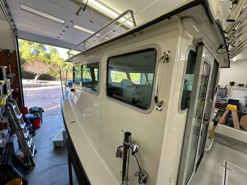 Slide: The Image of 2005 Farallon 28 boat in a garage, side view with windows and railing. - 18