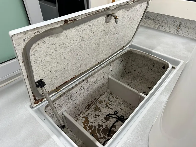 Slide: The Image of Open storage compartment on a 2005 Farallon 28 boat, showing interior details. - 20