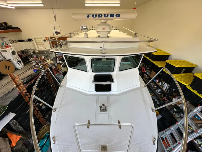 Slide: The Image of 2005 Farallon 28 boat in a garage, featuring Furuno radar equipment. - 26