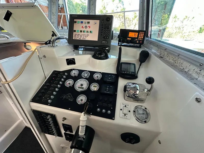 Slide: The Image of Control panel of a 2005 Farallon 28 boat with navigation and communication equipment. - 30