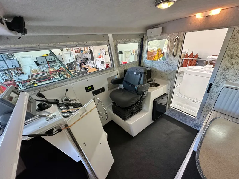 Slide: The Image of Interior of 2005 Farallon 28 boat with helm, seating, and navigation equipment. - 33