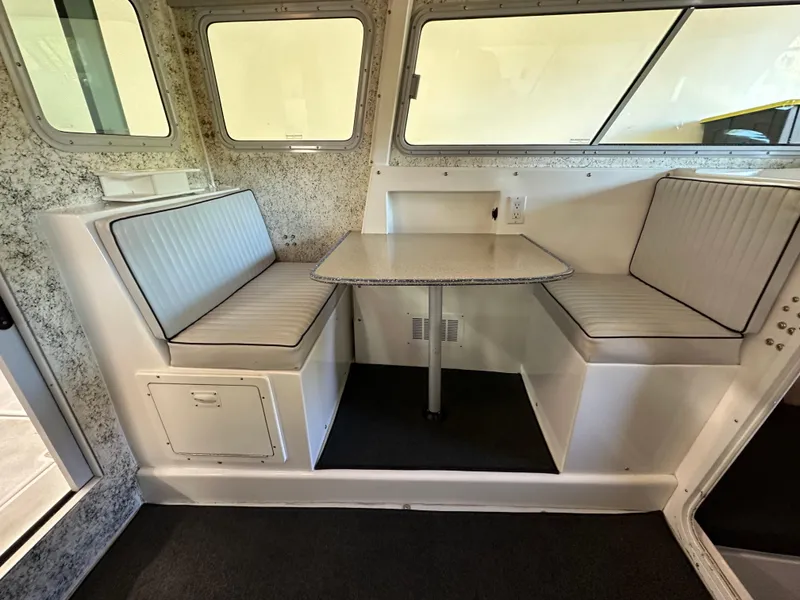 Slide: The Image of Interior of a 2005 Farallon 28 boat with a cozy dining area. - 38
