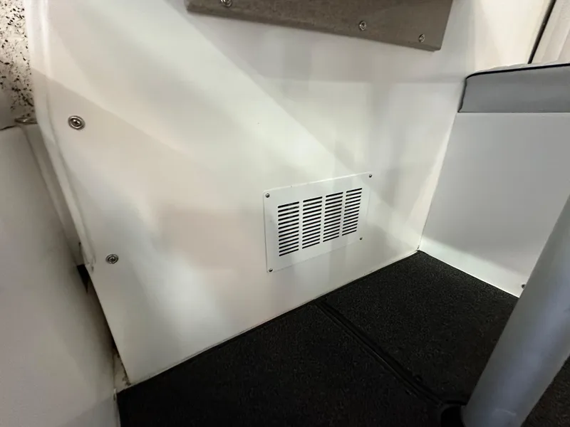 Slide: The Image of Interior view of a 2005 Farallon 28 boat, featuring a vent on a white wall. - 42