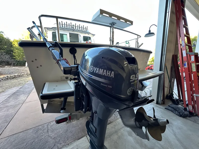 Slide: The Image of 2005 Farallon 28 boat with Yamaha 9.9 outboard motor in a garage. - 46