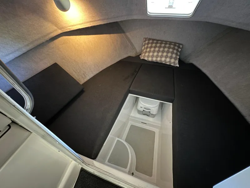 Slide: The Image of Cozy cabin interior of 2005 Farallon 28 boat with cushions and lighting. - 47