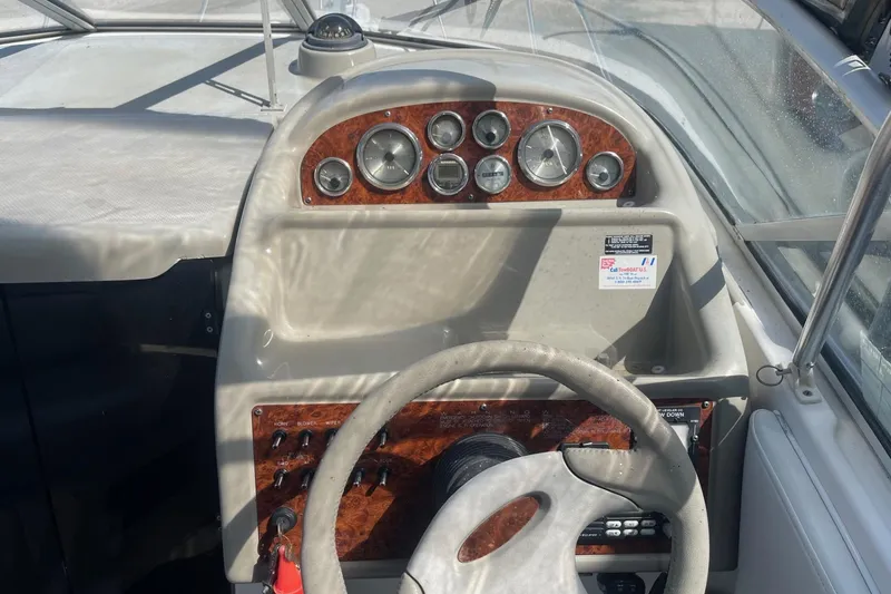 Slide: The Image of 1997 Bayliner 2655 Ciera boat dashboard with gauges and steering wheel. - 14