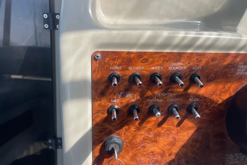 Slide: The Image of Control panel of a 1997 Bayliner 2655 Ciera boat with various switches. - 15