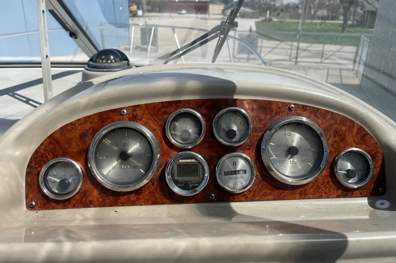 Slide: The Image of Dashboard of a 1997 Bayliner 2655 Ciera boat with gauges and controls. - 16
