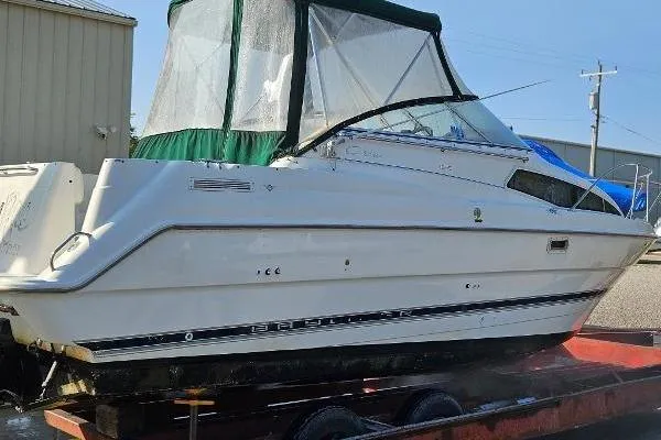 Slide: The Image of 1997 Bayliner 2655 Ciera cabin interior with sink, microwave, and curtains. - 26