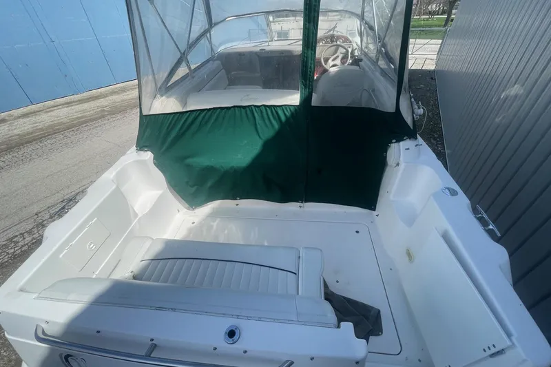 Slide: The Image of 1997 Bayliner 2655 Ciera boat with green canopy and white seating. - 7