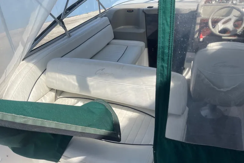 Slide: The Image of 1997 Bayliner 2655 Ciera boat interior with white seating and green canopy. - 8